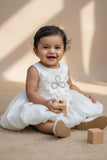 White Party Frock with Oversized Floral Appliqué and Pleated Shine Finish For Girls