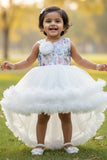 White Party Frock with Floral Bodice and Ruffled Hemline And Tailback For Girls