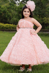 Peach Gown With Ruffled And Stone Waist Band For Girls