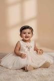 Fawn Party Frock with Oversized Floral Appliqué and Pleated Shine Finish For Girls