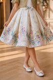Ivory Floral Party Wear Frock with Golden Jacket And Bow Waist Accent For Girls