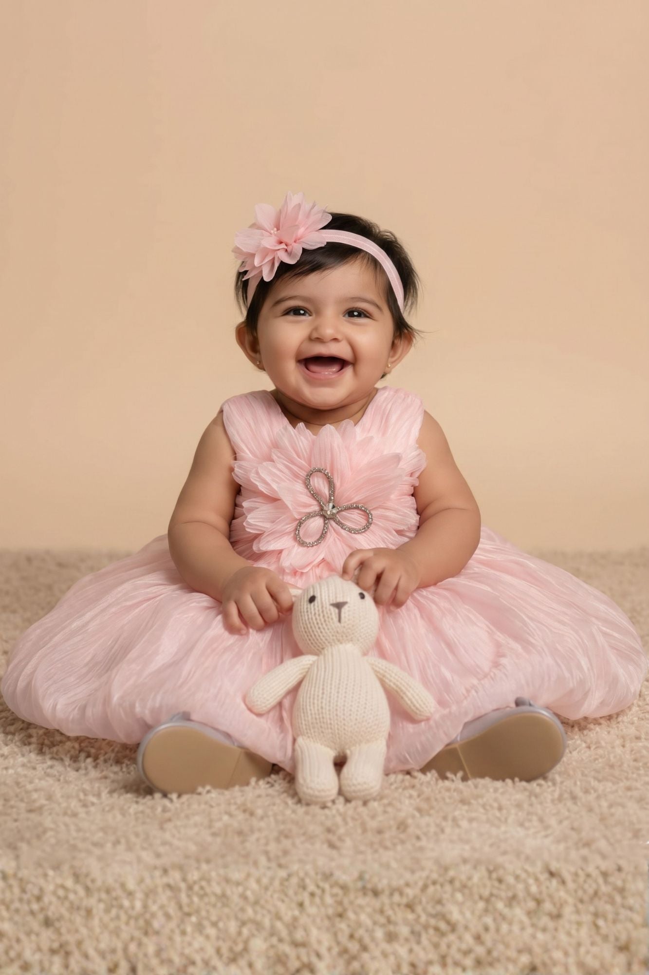 Peach Party Frock with Oversized Floral Appliqué and Pleated Shine Finish For Girls