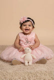 Peach Party Frock with Oversized Floral Appliqué and Pleated Shine Finish For Girls