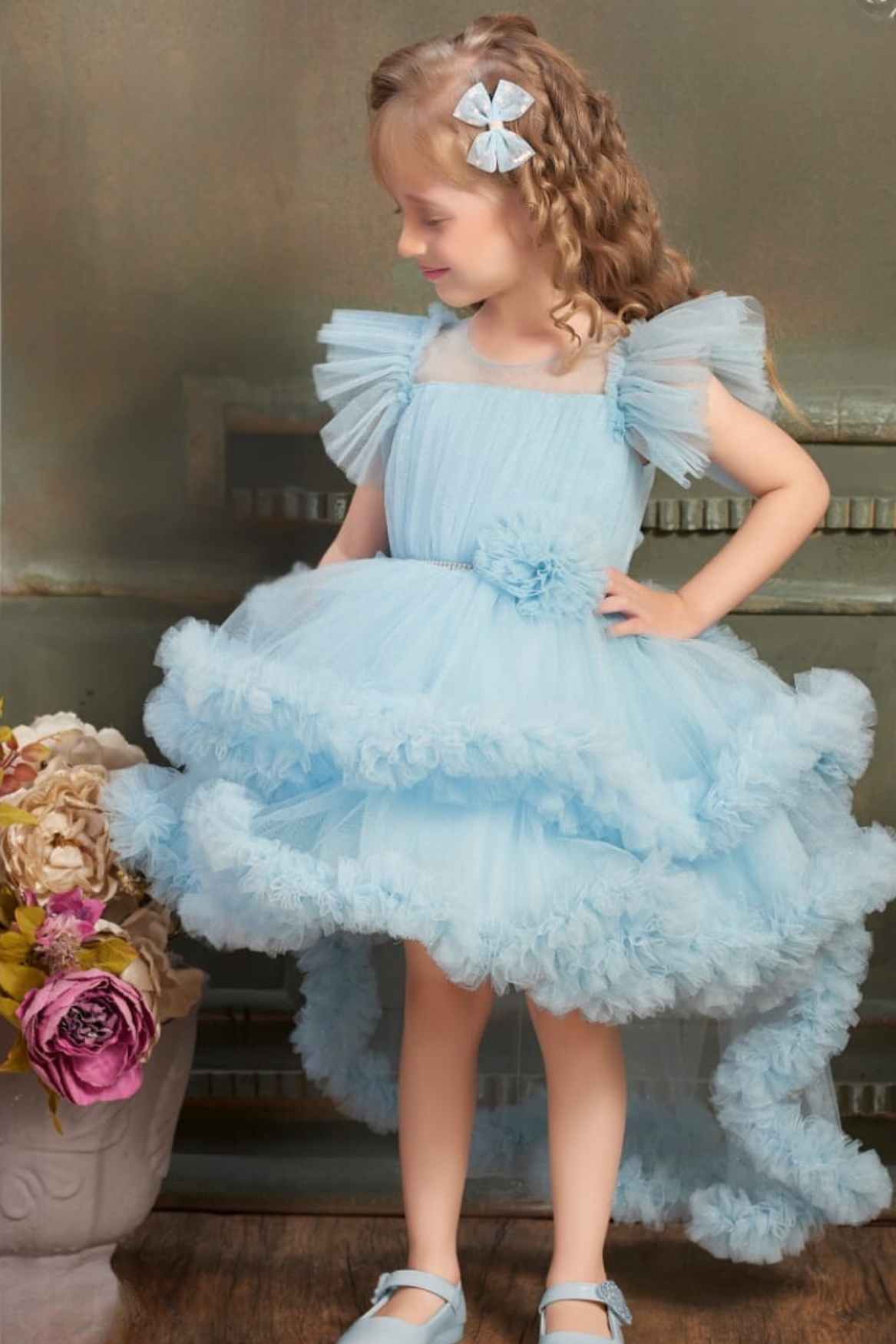 Ruffle Blue Multi-Layered Party Wear Frock With Flower Embellishment For Girls