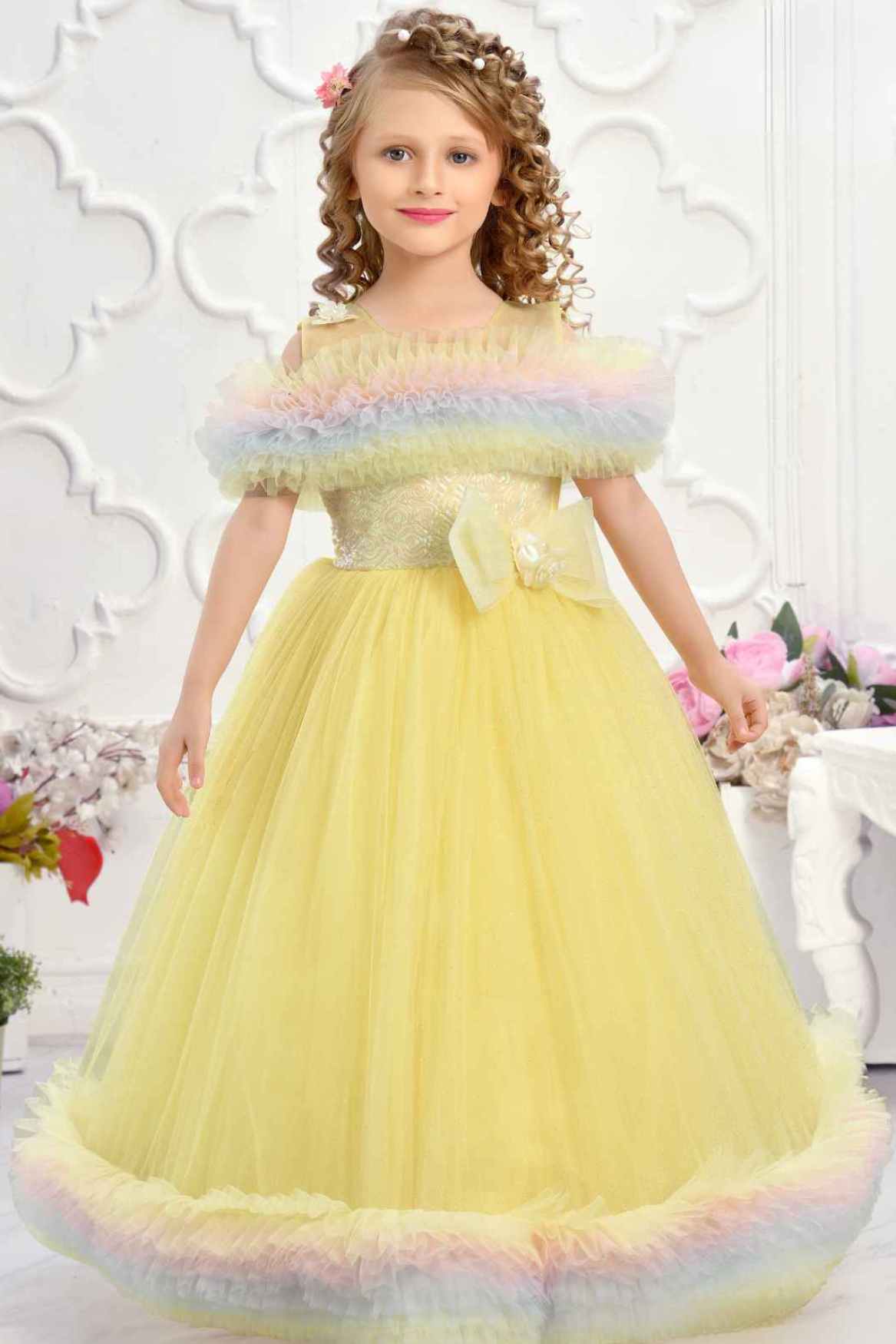 Yellow Ruffle Net Gown With Bow Embellishment For Girls