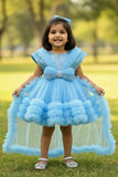 Blue Party Frock With Layered Ruffles And Statement Bow and Tailback For Girls