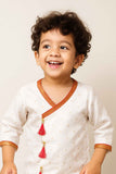 Elegant Cream And White Dhoti Kurta Set With Red Tassel Detailing For Boys