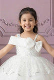 White Sequin Layered Ruffle Party Wear Frock With Statement Bow For Girls