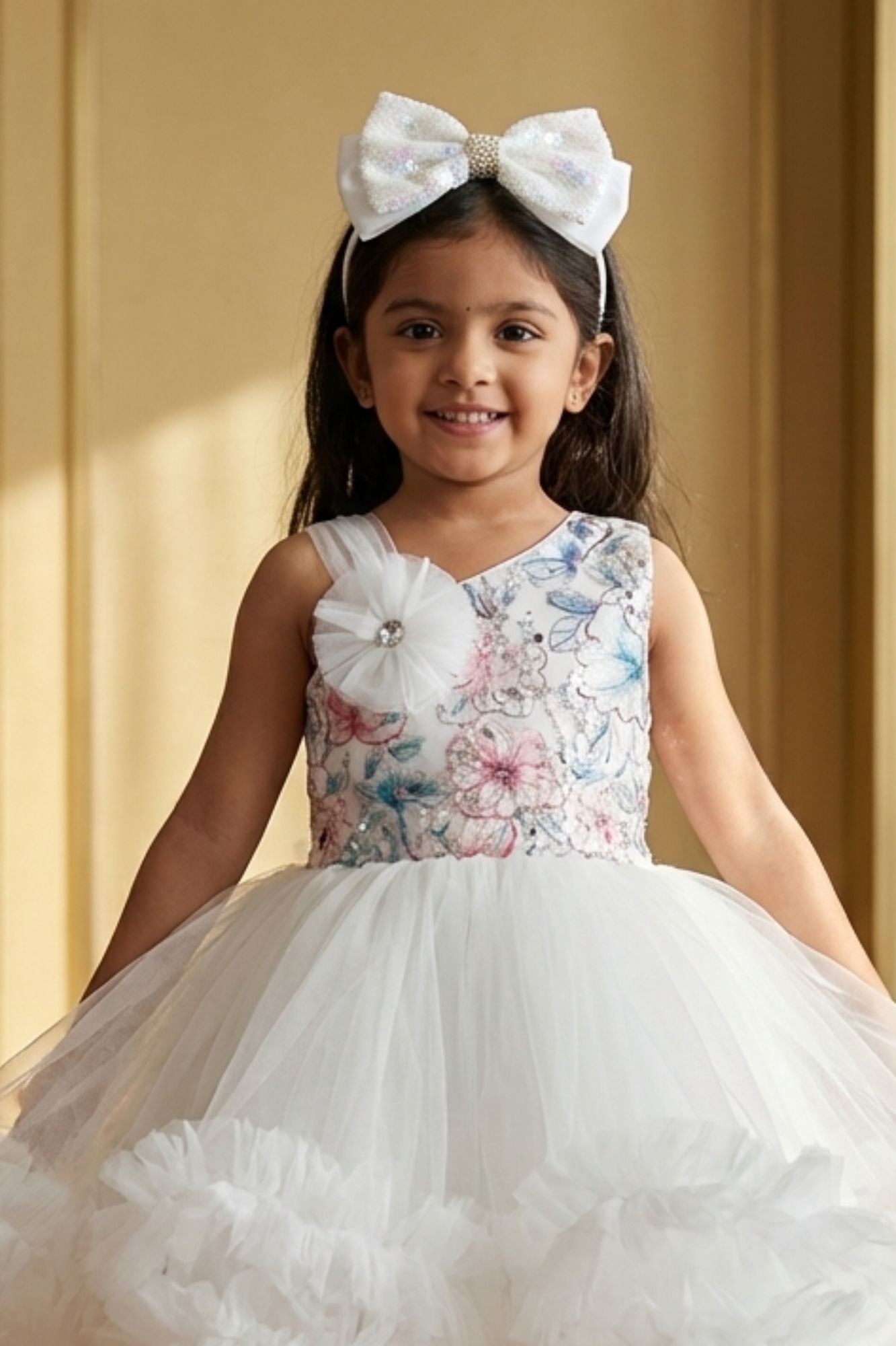 White Party Frock with Floral Bodice and Ruffled Hemline And Tailback For Girls