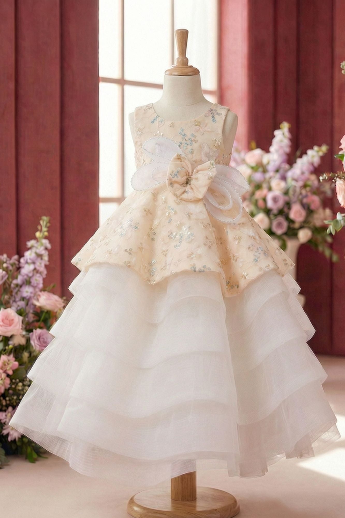 Girls Cream Layered Party Wear Gown with Floral Embroidery And Statement Bow