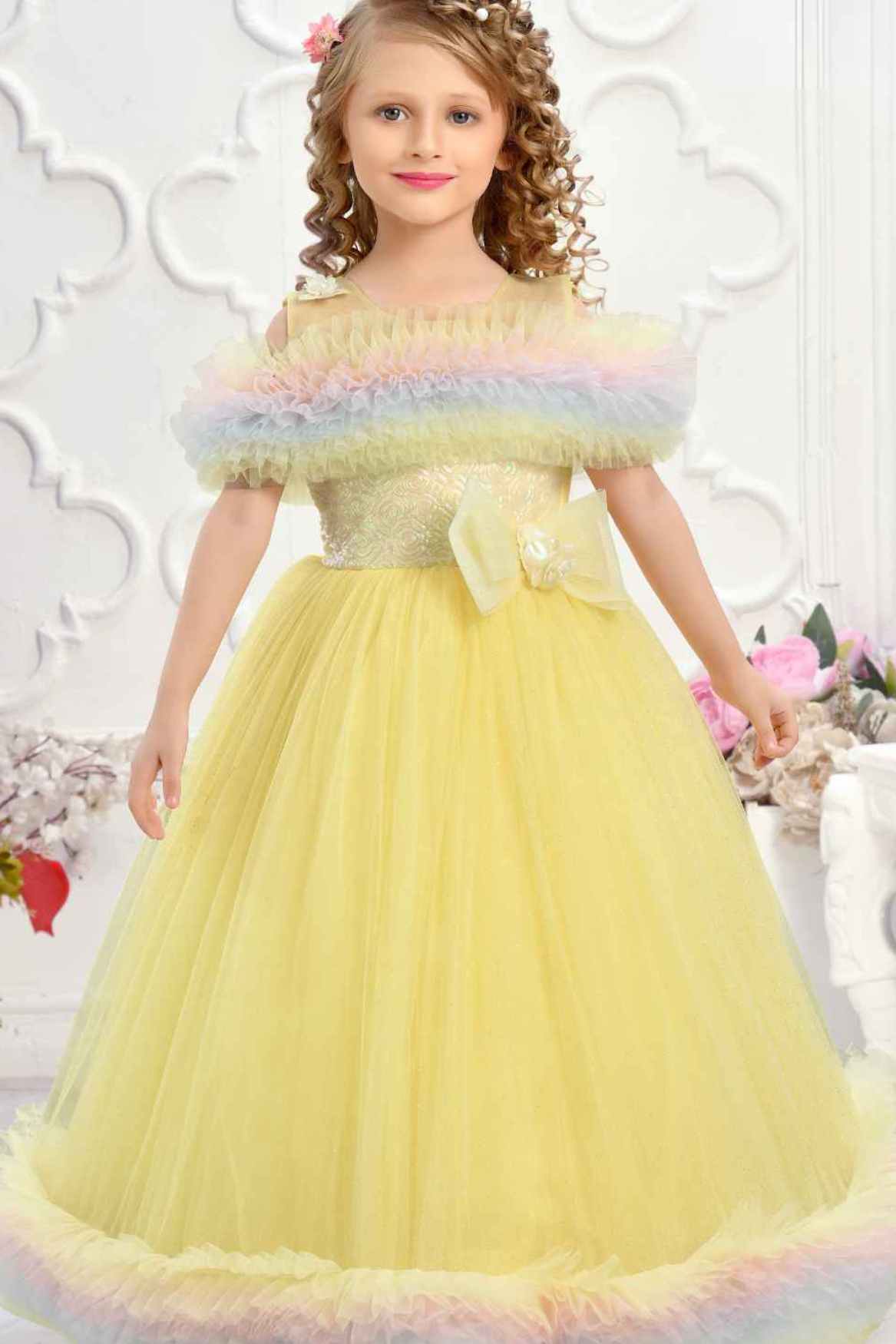 Yellow Ruffle Net Gown With Bow Embellishment For Girls