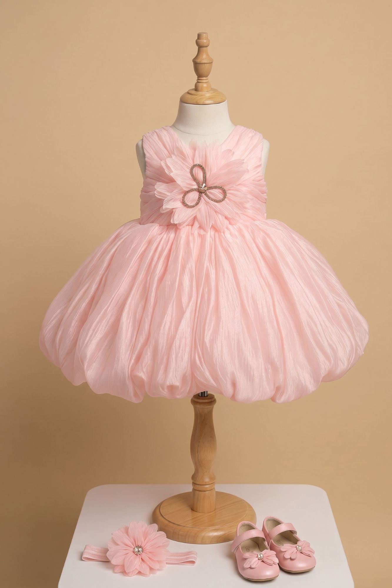 Peach Party Frock with Oversized Floral Appliqué and Pleated Shine Finish For Girls