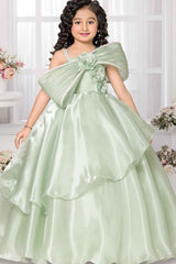 Pista Green Party Wear Gown With Floral And Bow Embellishment For Girls