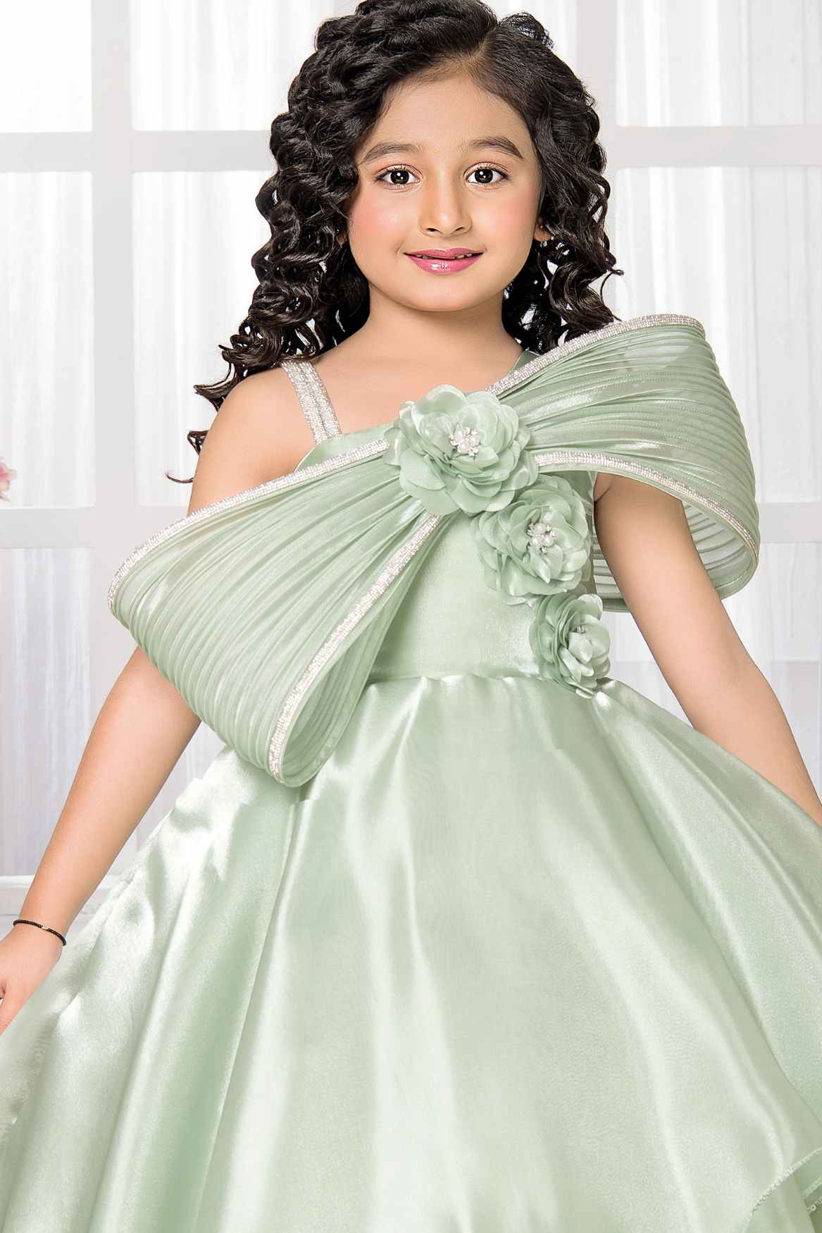 Pista Green Party Wear Gown With Floral And Bow Embellishment For Girl Lagorii Kids Pista Green Party Wear Gown With Floral And Bow Embellishment For Girl Lagorii Kids