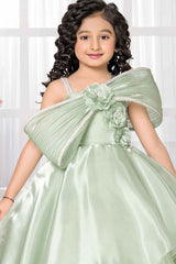 Pista Green Party Wear Gown With Floral And Bow Embellishment For Girls