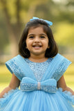 Blue Party Frock With Layered Ruffles And Statement Bow and Tailback For Girls