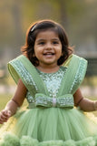 Pastel Green Party Frock With Layered Ruffles And Statement Bow and Tailback For Girls