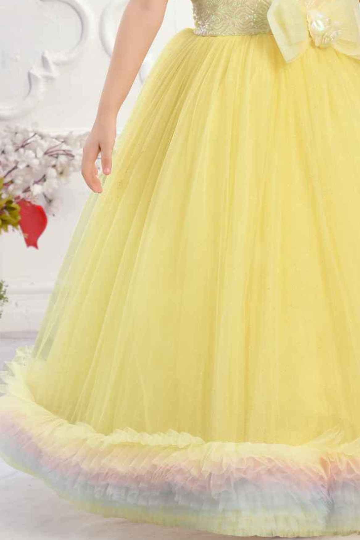 Yellow Ruffle Net Gown With Bow Embellishment For Girls