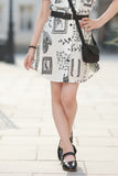 Cream And Black Abstract Printed Dress With Belt And Bag For Girls