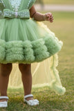Pastel Green Party Frock With Layered Ruffles And Statement Bow and Tailback For Girls