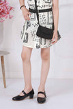 Cream Black Abstract Printed Dress With Belt And Bag For Girls