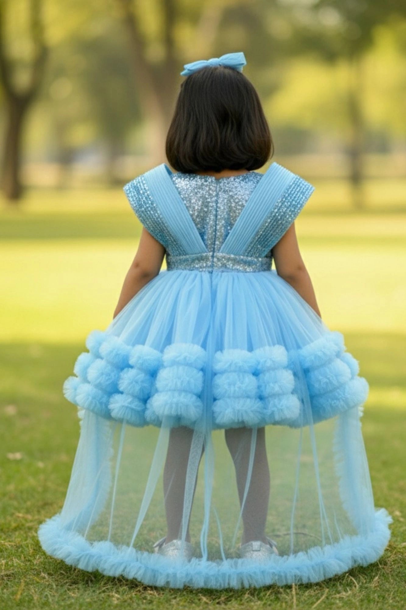 Blue Party Frock With Layered Ruffles And Statement Bow and Tailback For Girls