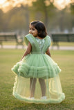 Pastel Green Party Frock With Layered Ruffles And Statement Bow and Tailback For Girls