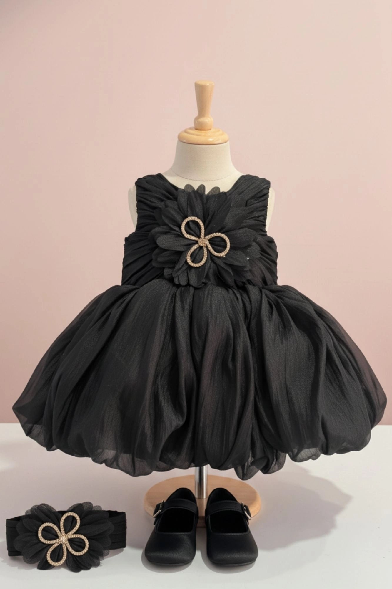 Black Party Frock with Oversized Floral Appliqué and Pleated Shine Finish For Girls