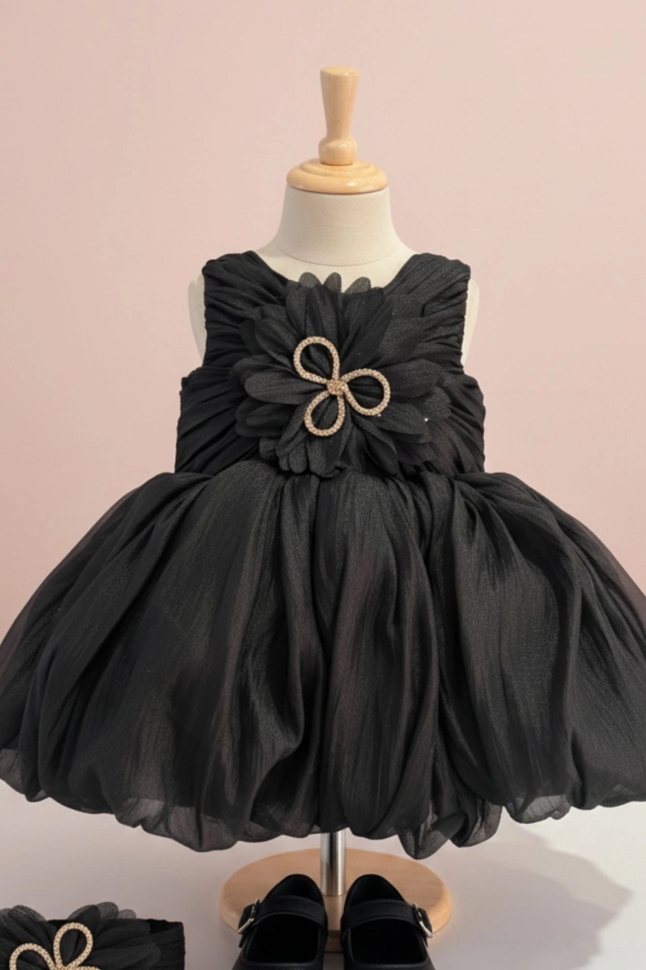 Black Party Frock with Oversized Floral Appliqué and Pleated Shine Finish For Girls