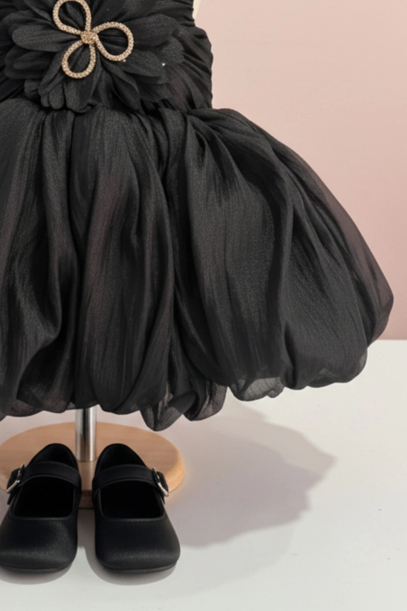 Black Party Frock with Oversized Floral Appliqué and Pleated Shine Finish For Girls