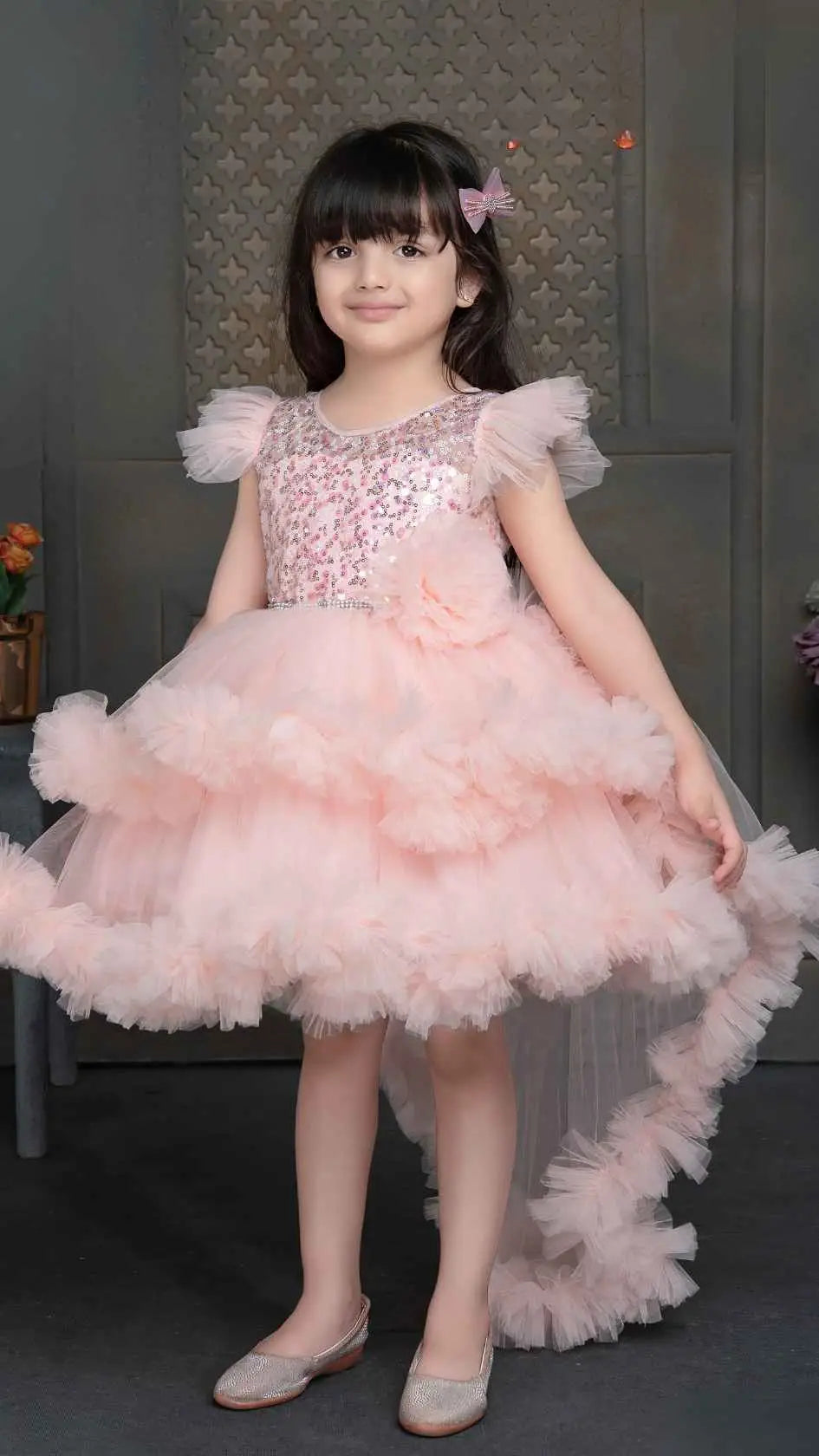 Peach Shimmer Tailback Party Wear Frock With Floral Embellishment For Girls