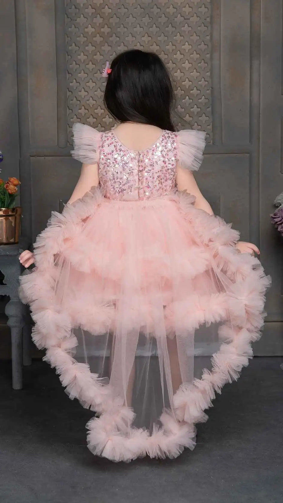 Peach Shimmer Tailback Party Wear Frock With Floral Embellishment For Girls