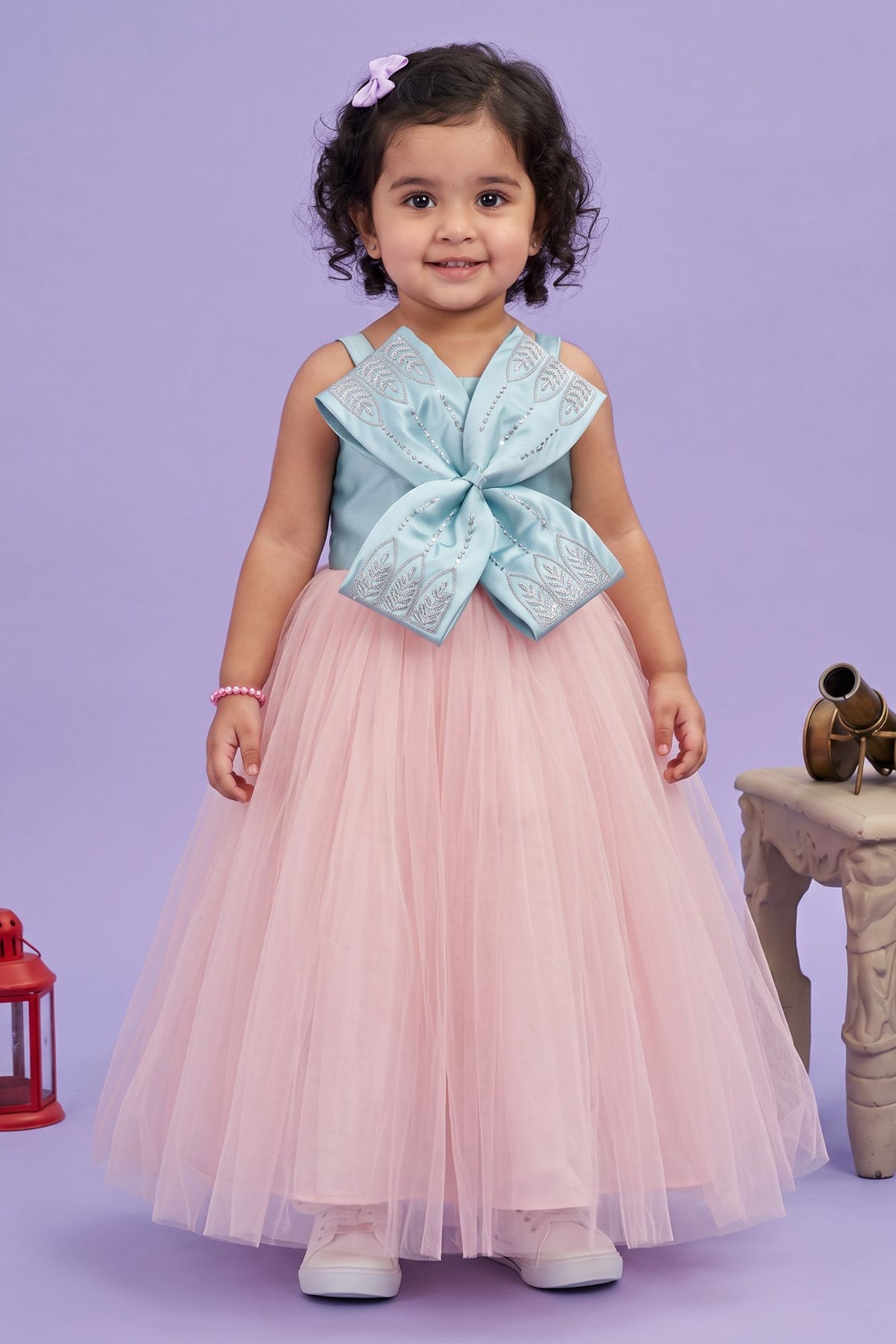 Designer Peach Gown Embellished With Blue Bow For Girls