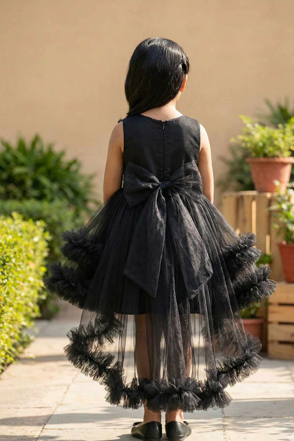 Black Party Frock with Floral Bodice and Ruffled Hemline And Tailback For Girls